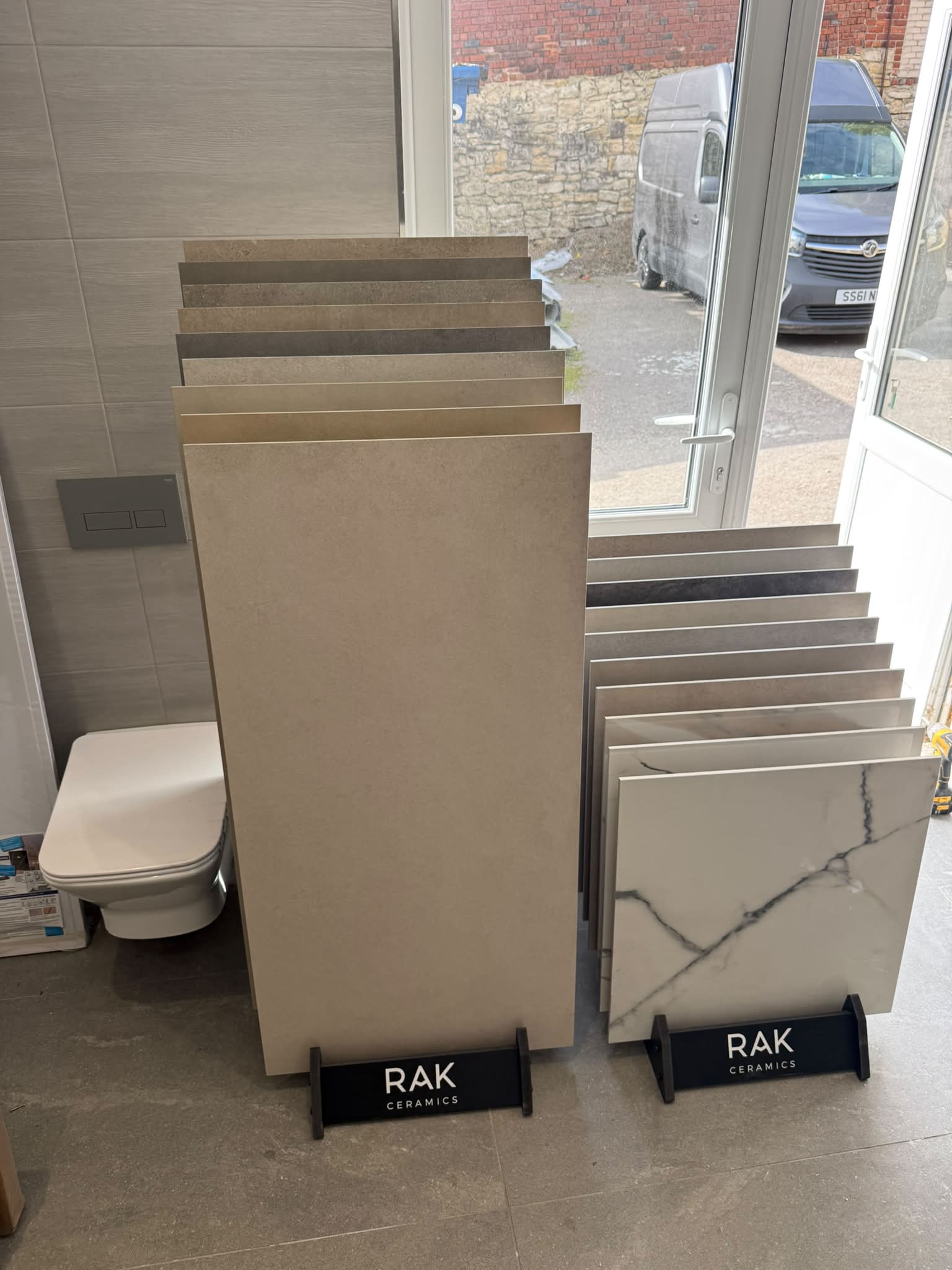 Inside The Plumbing House Kippax showroom featuring RAK Ceramics tile displays