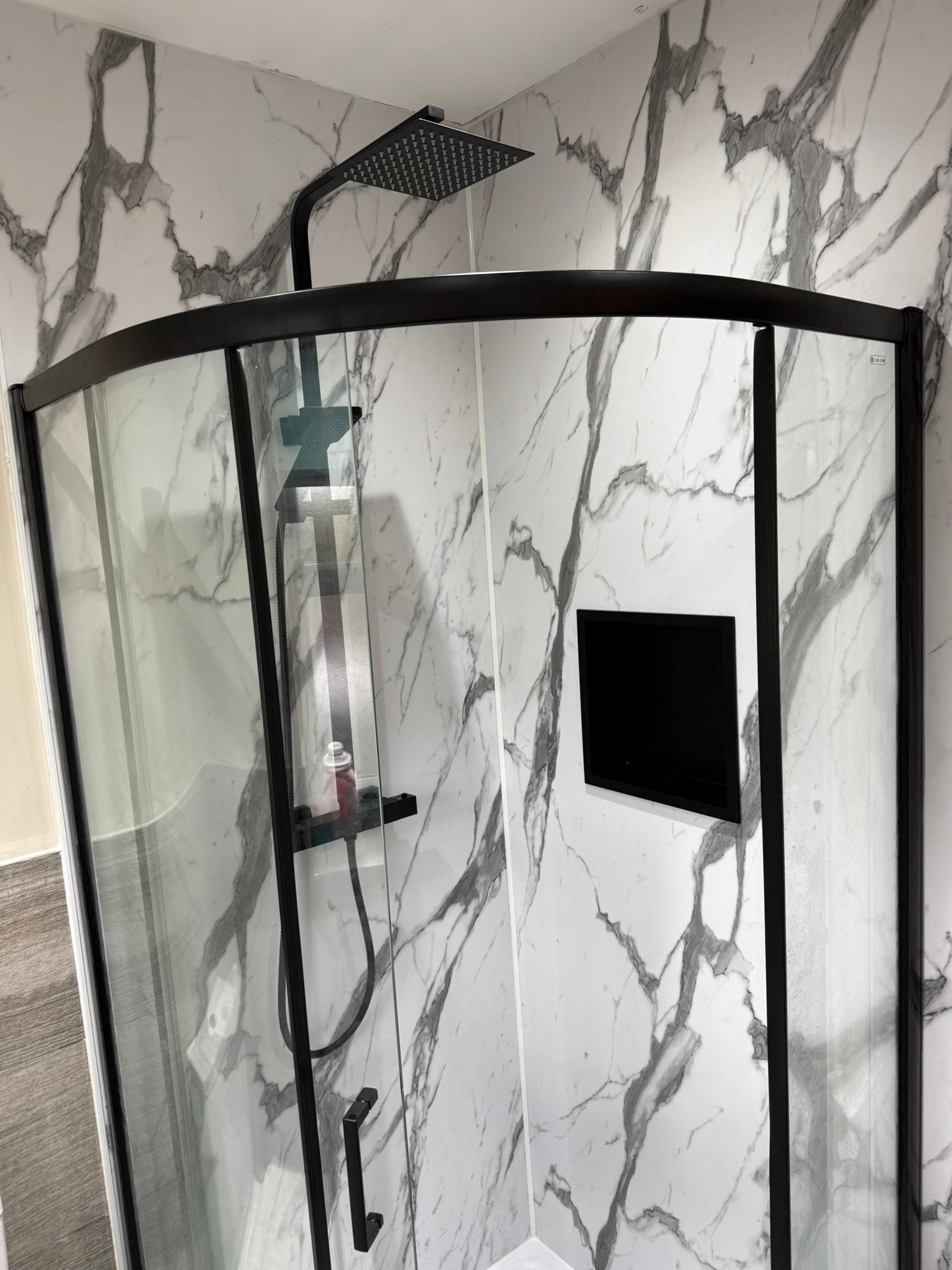 Customer bathroom installation — curved black quadrant shower enclosure